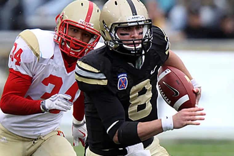 Army's Trent Steelman, right, runs past Virginia Military Institute's Juan Thrasher during a game in West Point, N.Y. (AP Photo/Craig Ruttle, File)