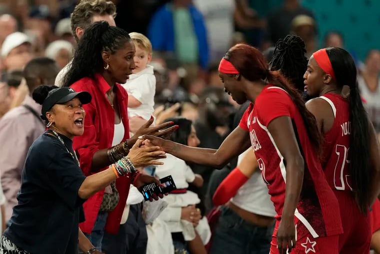 One Philly great greets another as South Carolina coach Dawn Staley (left) congratulates Kahleah Copper after the gold medal game in Paris.