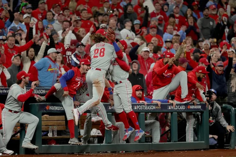 Edmundo Sosa of the Philadelphia Phillies celebrates with Alec Bohm (#28) after catching a foul ball to end the ninth inning and defeat the St. Louis Cardinals in game two to win the National League Wild Card Series at Busch Stadium on October 08, 2022 in St Louis, Missouri. (Photo by Stacy Revere/Getty Images)