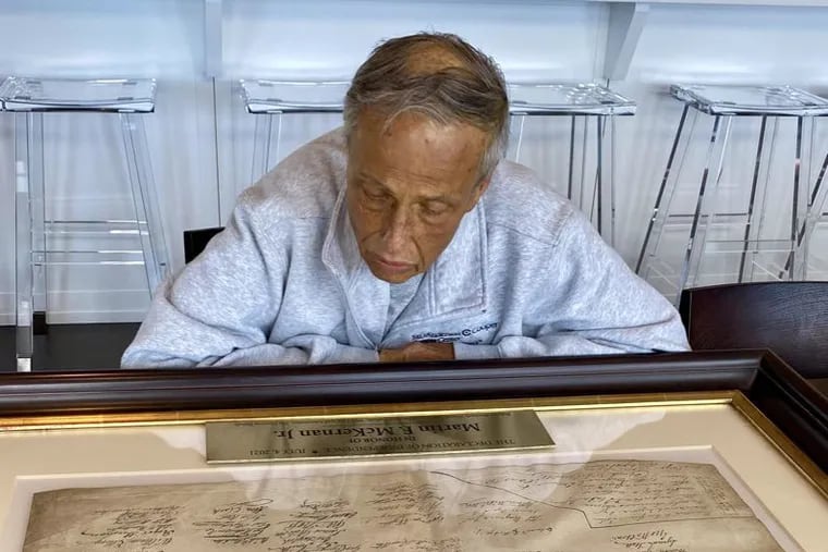 Martin F. McKernan Jr., long-time Norcross family friend, looks at the rare copy of the Declaration of Independence purchased by the family in his honor.