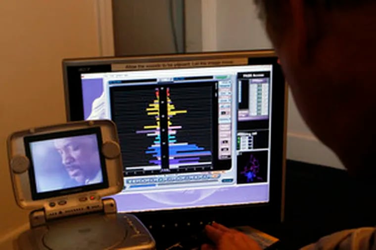 Neurofeedback practitioner Gary Ames prepares tools used to measure neural behavior. Insurance does not cover the cost of the technique, which can be up to $135 a week for 20 to 40 weekly sessions. Other scans can add $500 to $1,500 to the initial cost.