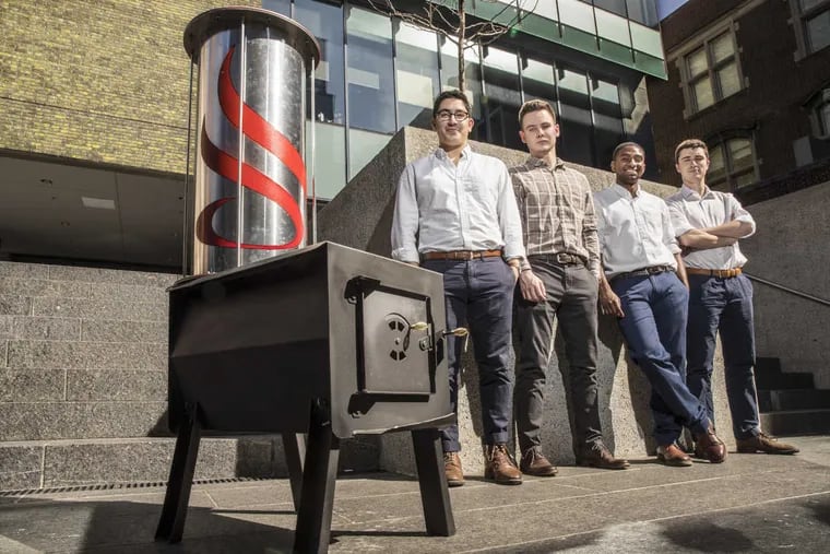 Mazin Blaik, Stephen Michalowski, Justin Gonsalves, and Kellen Sanna designed the cylinder on top of this traditional wood-burning stove for their senior engineering project at Penn. When filled with gravel, the attachment reduces heating costs by one-third, they said.