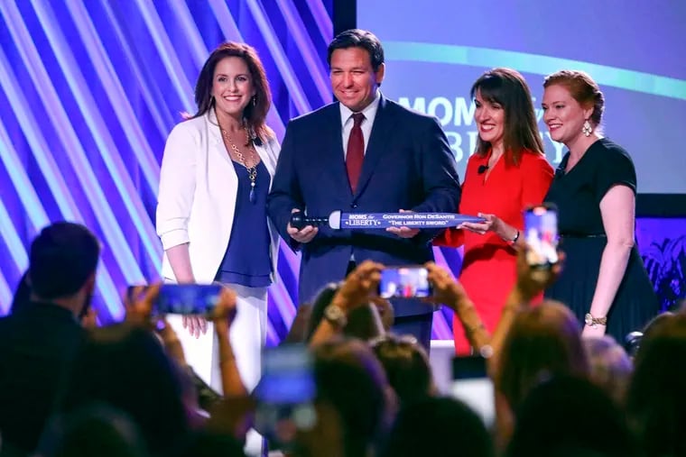 Florida Gov. Ron DeSantis is presented with "The Liberty Sword" during the Moms for Liberty national summit last July in Tampa. This year, Moms for Liberty is holding its summit in Philadelphia.