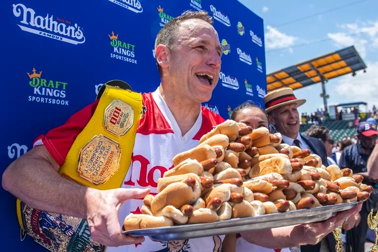 Joey Chestnut poses for photos in Coney Island's Maimonides Park after winning the 2021 Nathan's Famous Fourth of July International Hot Dog-Eating Contest.