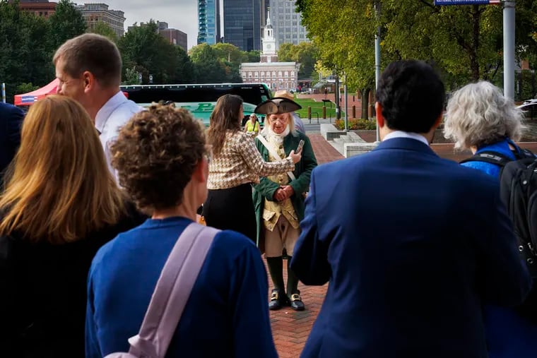 Bill Robling, reenactor dressed as Benjamin Franklin, is seen outside National Constitution Center. People were asking him for selfies. He was at the National Constitution Center on Constitution Day and Citizenship Day. The United States swore in 48 new citizens from 27 different countries at the NCC.