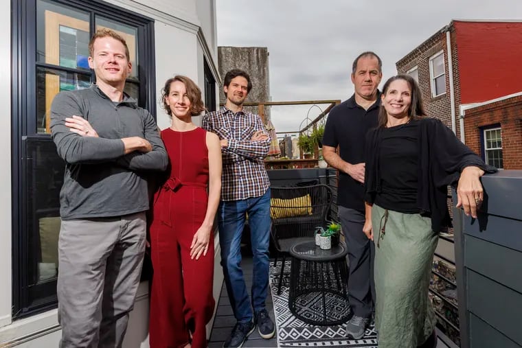 (From left) Architect David Niemiec; his wife, Jacklynn; and his brother Kevin Niemiec, all from Niemiec & Co. They redesigned the Philadelphia rowhouse of Natalie Pompilio (right) and Jordan Barnett (rear).