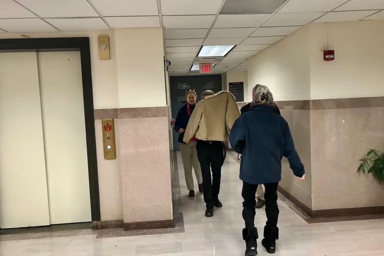 Harry Gramlich (center) shields himself from reporters as he leaves a courtroom in the Montgomery County Courthouse. Gramlich was found guilty of involuntary manslaughter in the death of his brother Timothy.