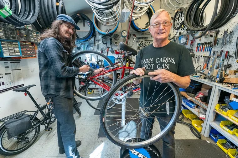 Aaron Tustin, left, and his father Rich Tustin working in their shop, the Erlton Bike Shop, in Cherry Hill, NJ, Wednesday, October 16, 2024.