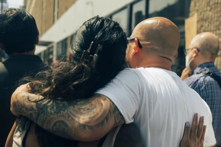 Sereyrath "One" Van embraces a friend during a rally in front of the ICE office in Philadelphia before his immigration check-in on Aug. 15.