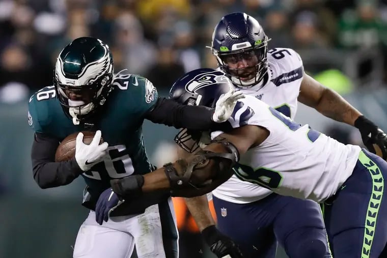 Miles Sanders, shown here rushing past Seahawks defensive linemen Rasheem Green in last season's NFC Wild Card game, is ready to return to action.