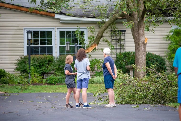 People view the damage at a home in Franconia Township, Montgomery County, on Thursday. The National Weather Service has confirmed that a tornado had touched down. An official said that 18 to 20 homes were damaged.