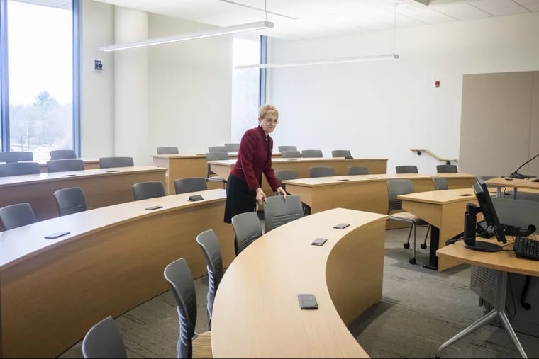 The new Rohrer College of Business building opened in January. Here, Dean Sue Lehrman shows off one of the new classrooms.