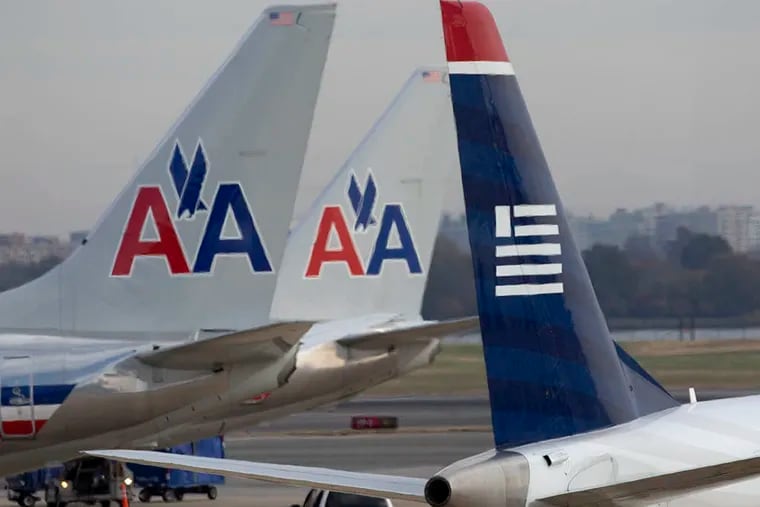 The more than 600 US Airways planes will be painted with the American Airlines colors late in 2016. (ANDREW HARRER / Bloomberg, File)