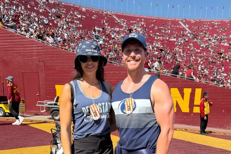 Jordan Mott (right) and his wife, Claire, in the tunnel at USC's Memorial Stadium. Mott ran out on the field with the Trojans in full Penn State gear.