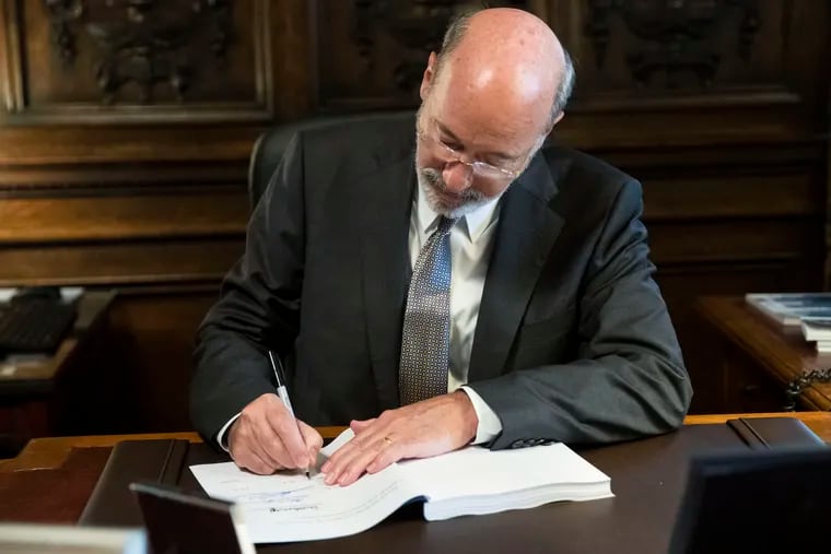 Pennsylvania Gov. Tom Wolf signs the main appropriations bill in a $34 billion budget package that passed the Legislature on June 28, 2019 at the state Capitol in Harrisburg. The budget did not include a statewide minimum wage increase.