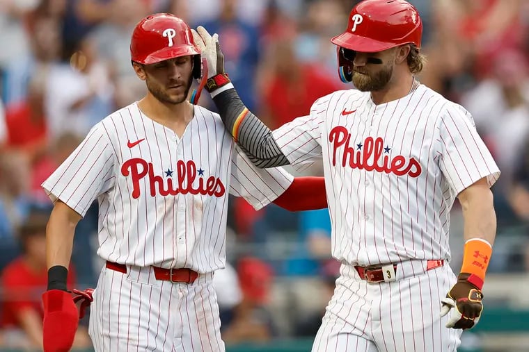 The Phillies' Bryce Harper (right) celebrates his two-run homer against the Guardians with Trea Turner on July 27.