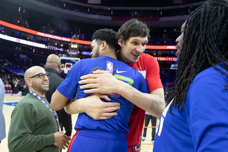 Tobias Harris (2nd from left) and former teammate Boban Marjanovic embrace after a game on Feb. 13, 2023. Marjanovic will join EuroLeague team Fenerbahce.