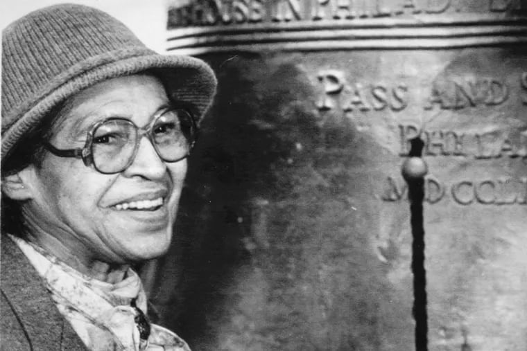 Rosa Parks ceremonially strikes the Liberty Bell in honor of the Rev. Martin Luther King Jr. in Philadelphia on Jan. 18, 1988.