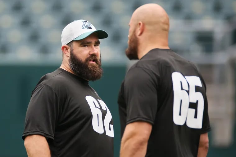 Eagles center Jason Kelce (62) talks with tackle Lane Johnson (65) during practice at Lincoln Financial Field in South Philadelphia on Friday, June 4, 2021.