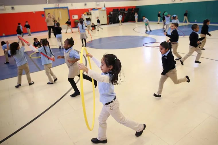 Kindergarten students run around during recess in the gymnasium at Camden’s Pride Charter School in Camden, N.J., on Wednesday.