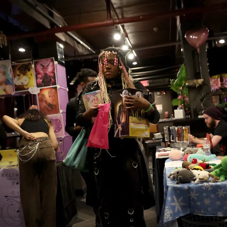 A visitor, who identified themself as Jazz, makes a few purchases at SAIKA Cafe’s first Anime Maker's Market event inside The Velvet Whip in Philadelphia, on Sunday, June 30, 2024. SAIKA Cafe is a series of monthly pop up events featuring nerd-themed and East Asian culture based content from anime, comics, movies and games.