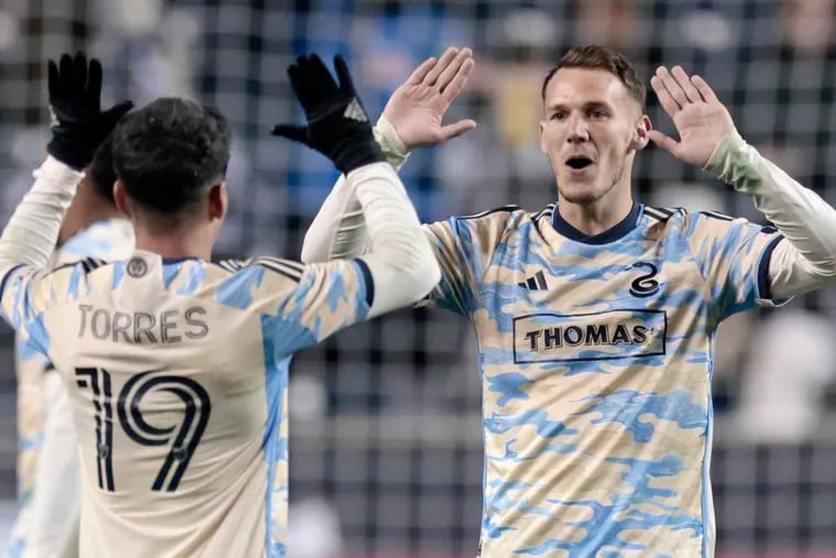 Joaquín Torres (left) and Dániel Gazdag (right) celebrate after one of the Union's goals in their season-opening 4-1 rout of Columbus at Subaru Park last Saturday.