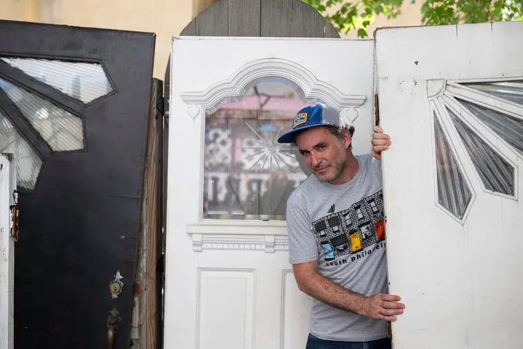 Tony Trov, cofounder of the T-shirt shop and lifestyle brand South Fellini, shows off some of his collection of Tofani doors. The Atwater Kent Collection plans on adding one of Trov's doors to its permanent collection.