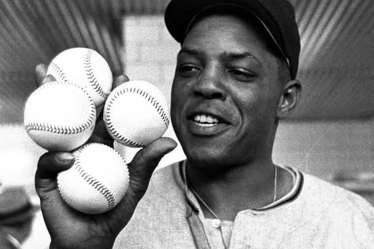 San Francisco Giants outfielder Willie Mays displays the four baseballs in the clubhouse representing the four homers which he hit against the Milwaukee Braves, April 30, 1961, in Milwaukee.