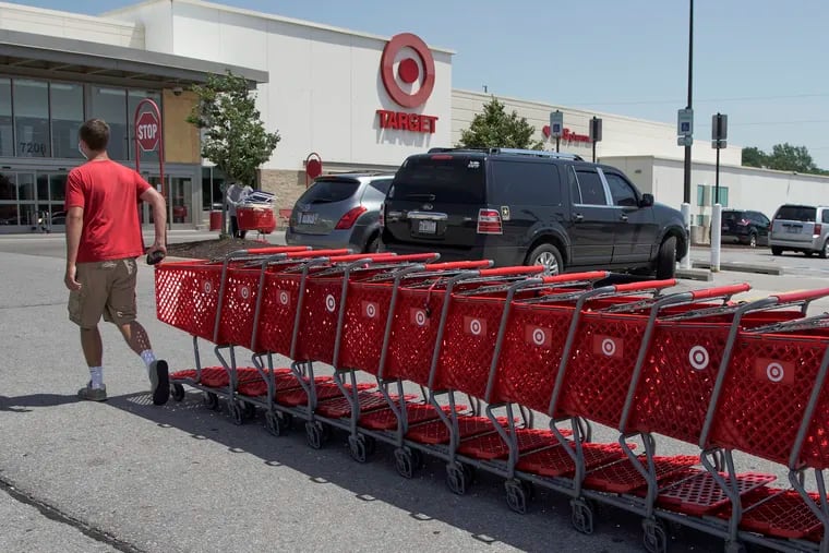 Target employee returns shopping carts from the parking lot outside a store in Omaha, Neb., on June 16.