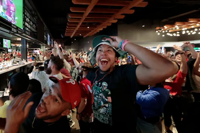 Philadelphian’s Jeremy Jordan (left) and Steven Lewis (right) cheer for the Phils in the fifth inning as they watch both the Phillies World Series and Eagles games at the Wells Fargo Center on Thursday, Nov. 3. The Phils lost the game 3-2. The Wells Fargo Center opened up to fans free of charge.