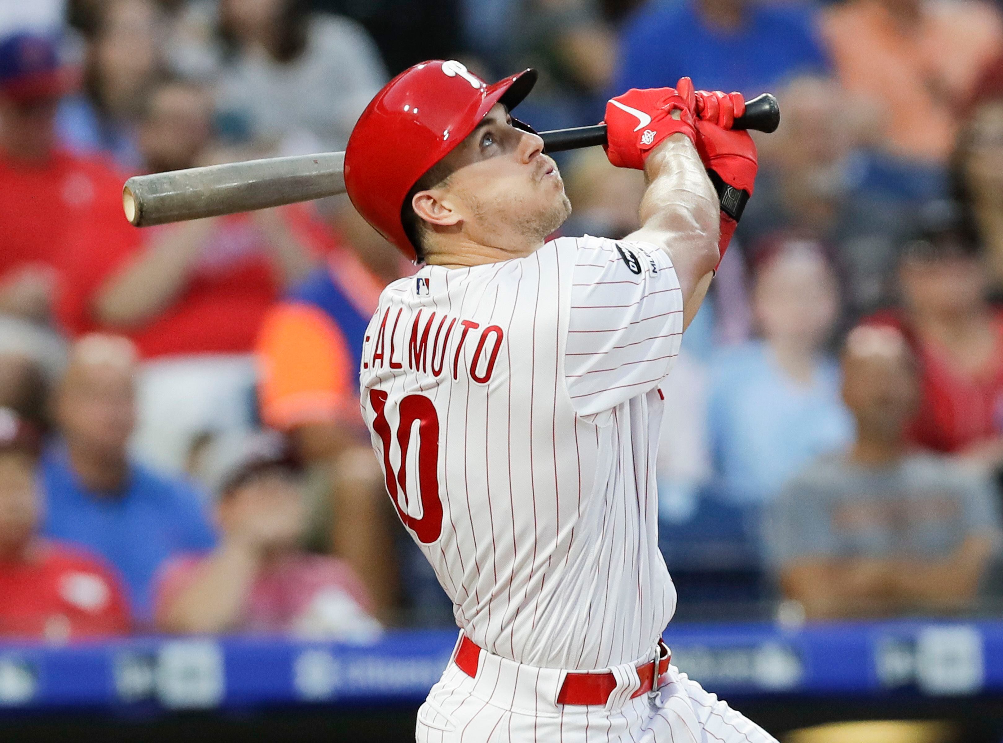 Philadelphia Phillies - Photo of J.T. Realmuto on the field with three 2022  season awards in front of him. From left to right, Realmuto received the  Silver Slugger award, All-MLB First Team