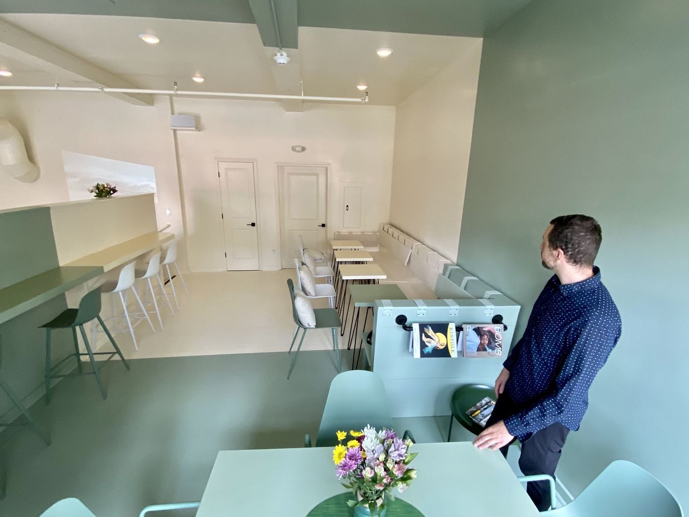 Co-owner Sean Kligerman surveys the loft seating area at Forin Cafe.