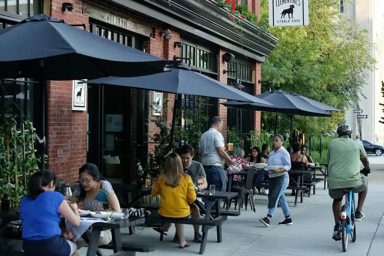 Diners sit outside at Clementine's Stable Cafe along North Broad Street.