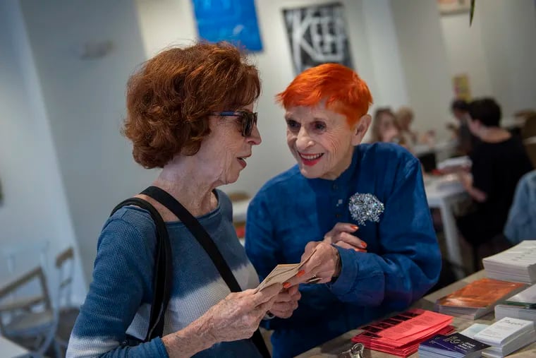 Tina Caruso, a 91-year-old hostess at Frieda cafe, talks with Sheila Kennedy, a Queen Village resident.