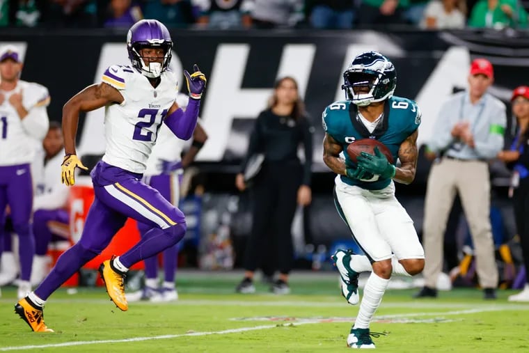 Eagles wide receiver DeVonta Smith makes a third-quarter catch and scores a touchdown past Minnesota Vikings cornerback Akayleb Evans.