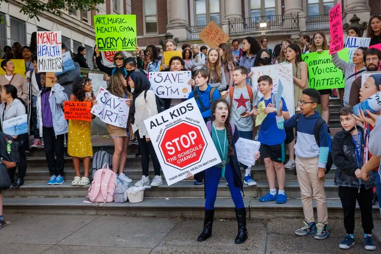 Masterman students gather before school Thursday to protest changes that would mean some middle school students would no longer have art and music. More than 300 people showed up to rally against the changes, which are planned for the fall. School and district officials say the changes will streamline Masterman's schedule, add opportunities for high school students, and do not reduce instructional time, a notion many parents reject.