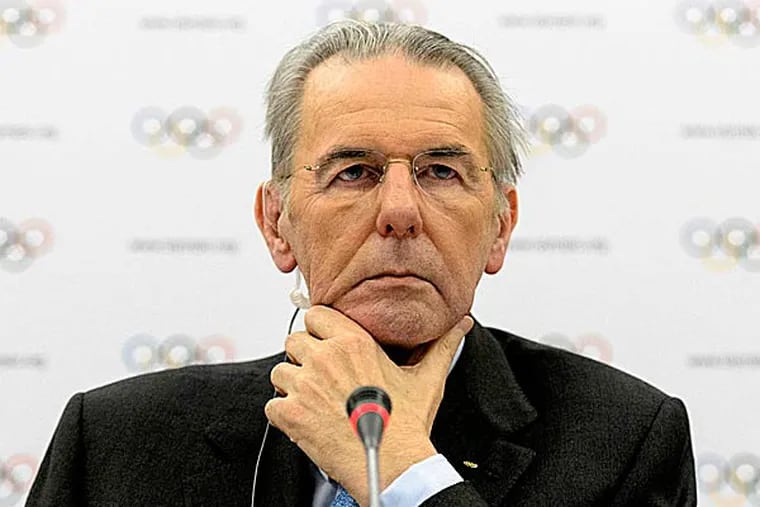 IOC president Jacques Rogge will meet with the head of wrestling's governing body to discuss ways the sport can fight to save its place in the Olympics. (Laurent Gillieron/Keystone/AP)