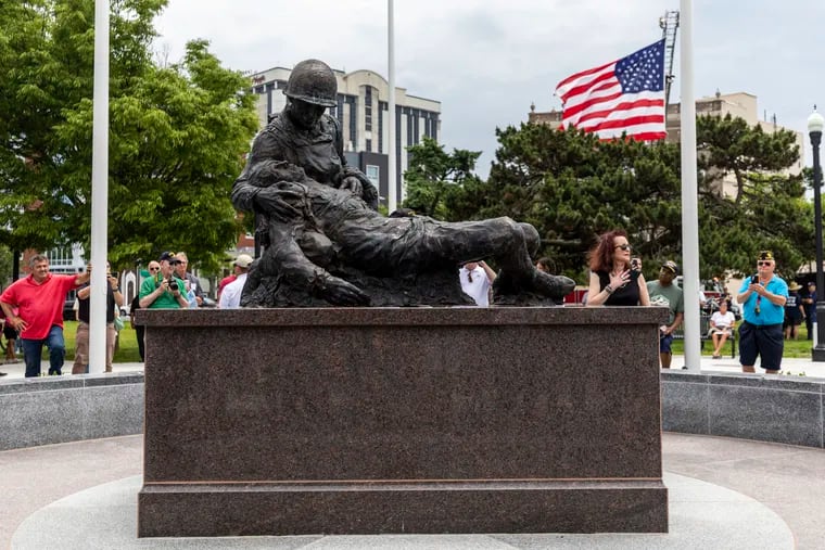 Susan Friedenberg, daughter, unveils the statue during the Bernie Friedenberg World War II Memorial unveiling and Dedication Ceremony at O’Donnell Memorial Park in Atlantic City, N.J., on Thursday, June 6, 2024.