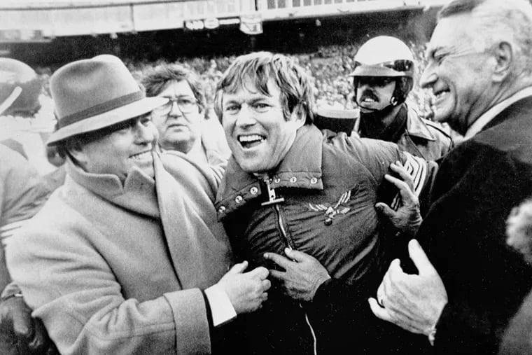 Eagles owner Leonard Tose, right, and general manager Jim Murray hug coach Dick Vermeil following the Birds' 20-7 victory over the Dallas Cowboys at NFC championship game in Philadelphia, Jan. 11, 1981. The victory gives the Eagles a berth in the Jan. 25 Super Bowl. (AP Photo)