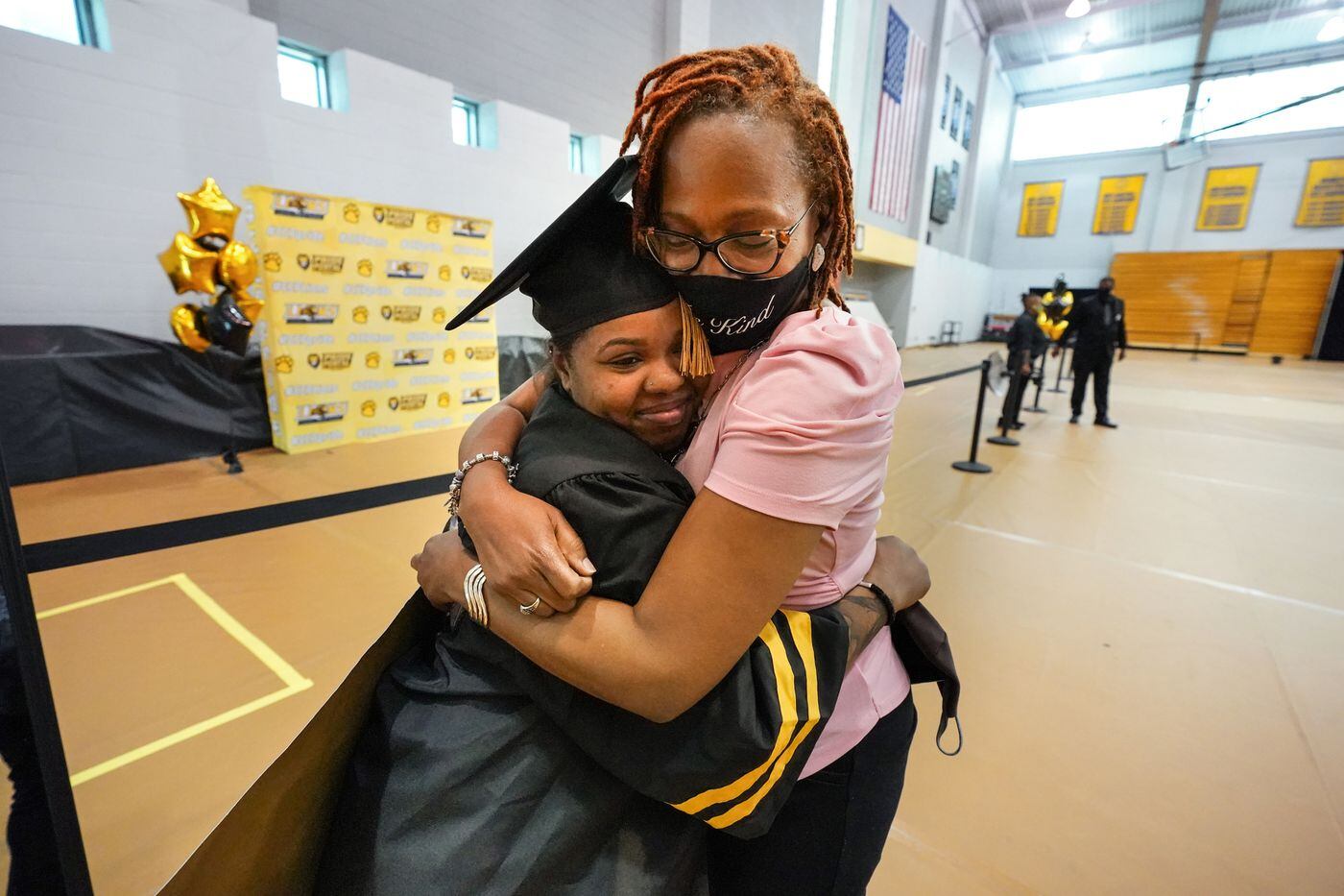 Laila Manigo gets a hug from Taara Green, academic and internship support coordinator at Parkway Center City Middle College. Green, a Philadelphia School District employee, provided academic support to Manigo and other students who earned a high school diploma and an associate's degree from the Community College of Philadelphia -- at the same time.