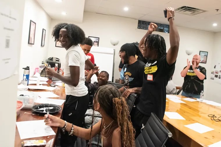 Student participants and instructors of the Students Talking About Relationships program react during an exercise at the Lutheran Settlement House in Fishtown.