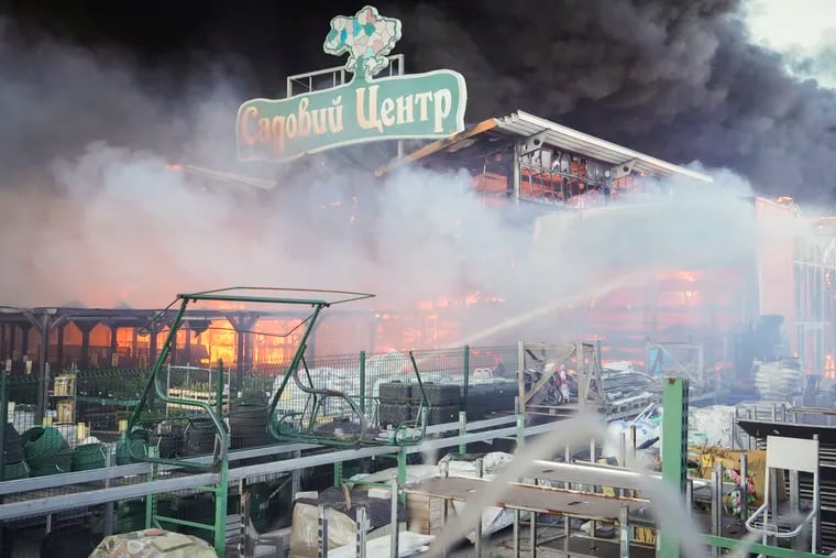 Firefighters put out a fire after two guided bombs hit the Epicenter shopping complex in Kharkiv, Ukraine, in May, as part of Moscow's deliberate campaign against civilian targets. The sign reads "Garden Center."