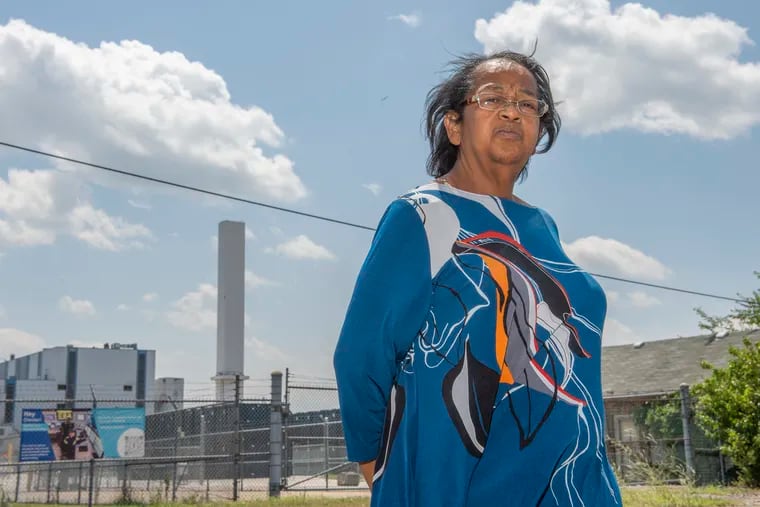 Zulene Mayfield stands in front of the Delaware Valley Resource Recovery Facility in Chester, Pa. Mayfield is a long-time opponent of the facility.