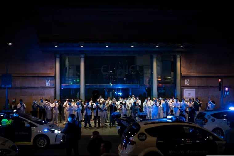 Health workers gathered outside the Hospital Clinic joining applause by police officers and residents in support of the medical staff that are working on the COVID-19 virus outbreak in Barcelona, Spain on Monday.