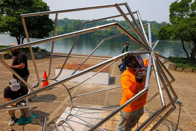 Travis Johnson with Atelier Fine Art Services welds Vessel 10 from Maren Hassinger’s “Steel Bodies” exhibit at the Ellen Phillips Samuel Memorial on Kelly Drive. Photographs from installation on Wednesday, June 7, 2023.