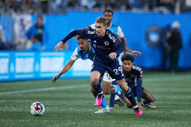 Young midfielder Noel Buck (center) has helped the New England Revolution deliver one of MLS's stingiest defenses this season.