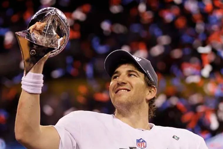 New York Giants quarterback Eli Manning celebrates with the Vince Lombardi Trophy after the Giants' 21-17 win over the New England Patriots in the NFL Super Bowl XLVI football game Sunday, Feb. 5, 2012, in Indianapolis. (AP Photo/Mark Humphrey)