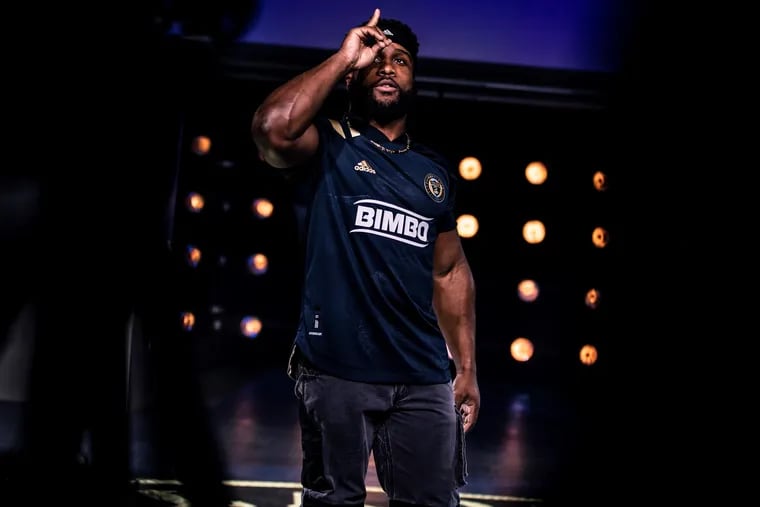 Eagles running back Boston Scott showing off the Union's new jersey for the 2020 season at an unveiling event.