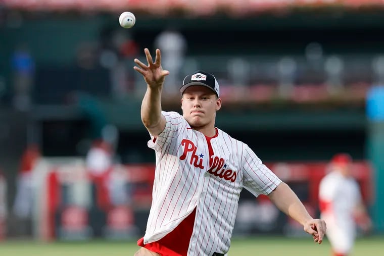 Flyers rookie Matvei Michkov throws the ceremonial first pitch before the Phillies played the New York Yankees on Monday.