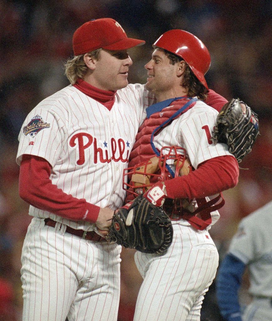Philadelphia Phillies starting pitcher Curt Schilling covers his head with  a towel in the dugout after Mitch Williams took over from him in the ninth  inning of game 5 of the National